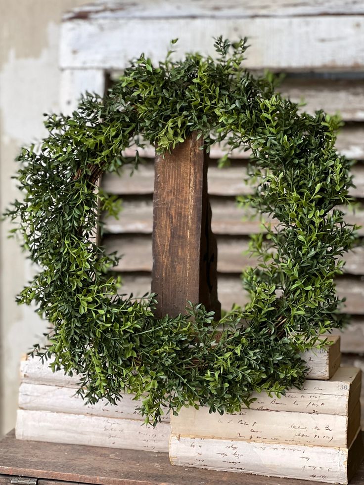 a wreath is sitting on top of a wooden box