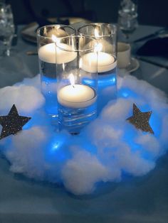 some candles are sitting in the clouds with stars on them