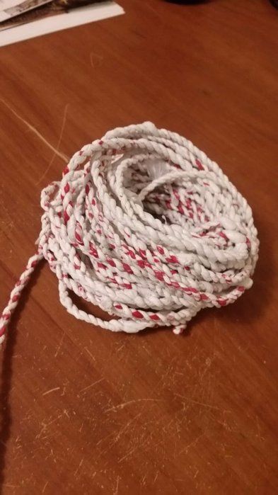 a white and red rope on a wooden table