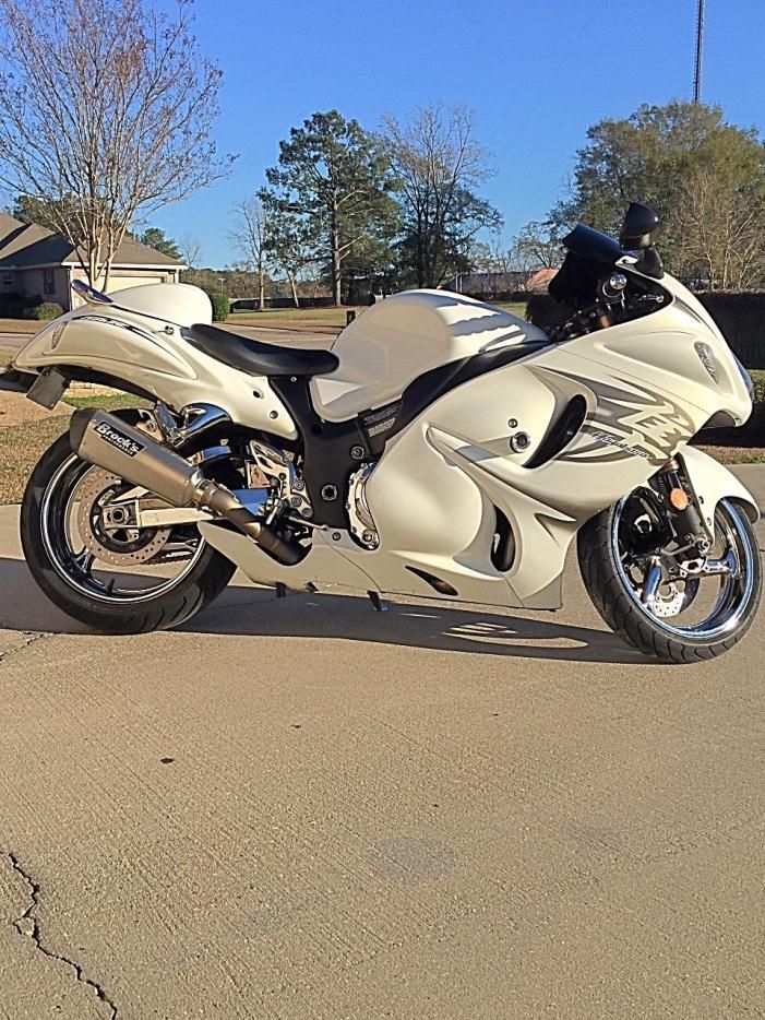 a white motorcycle is parked on the street