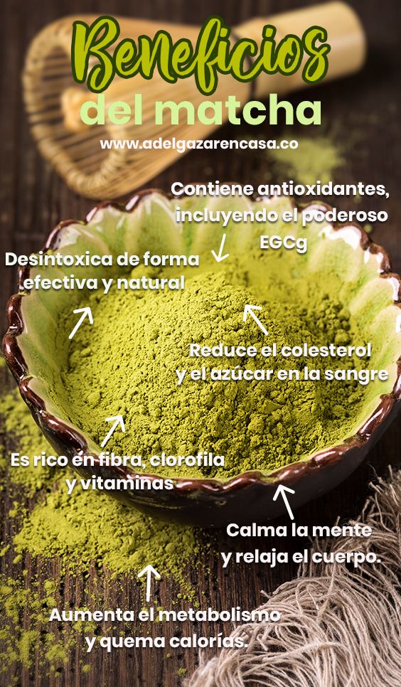 a bowl filled with green powder on top of a wooden table