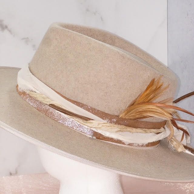 a white hat with feathers on top of it