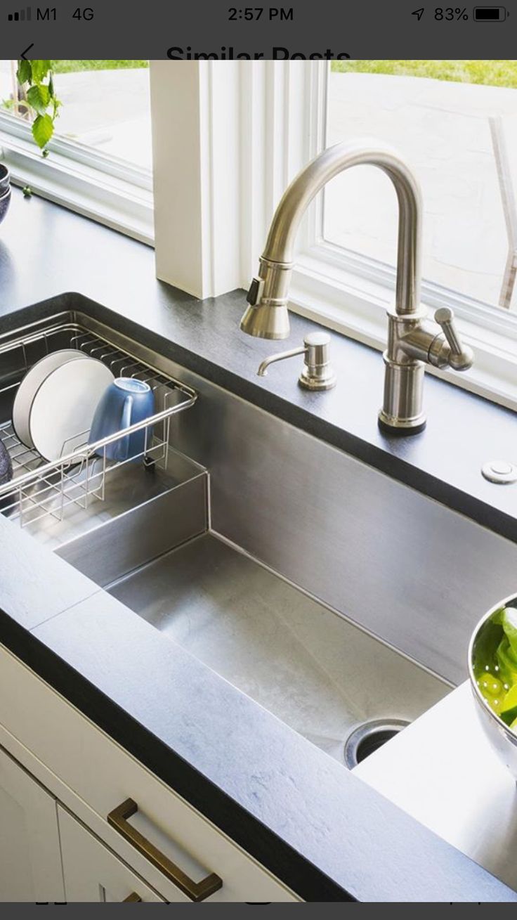 a kitchen sink with dishes in it next to a window