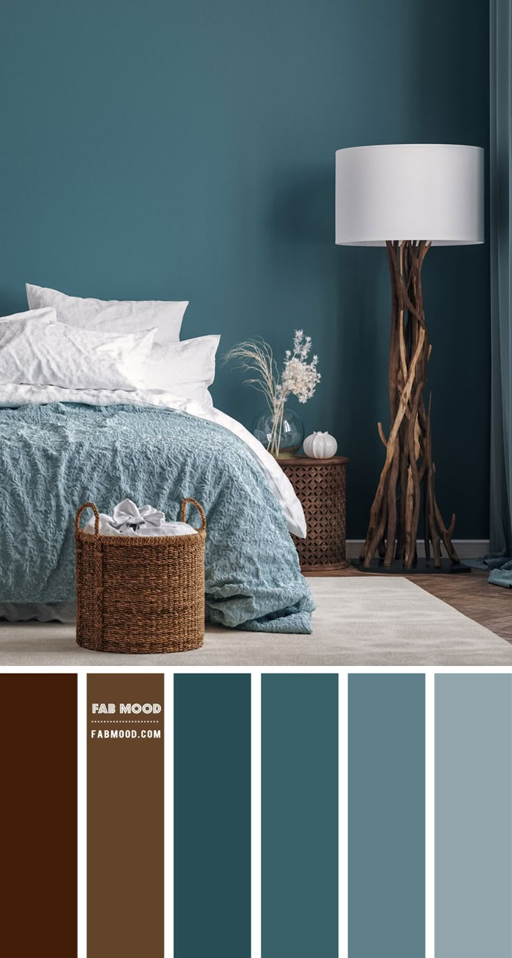 a bedroom with blue walls, white bedding and brown accents in shades of teal