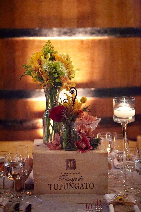 the table is set with flowers and wine glasses