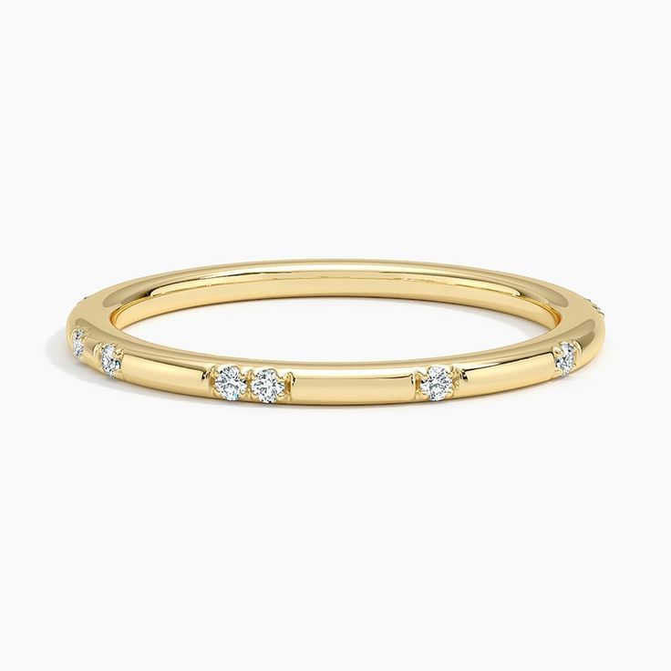 a yellow gold band with diamonds on it