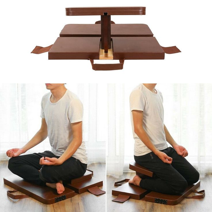 a man sitting on top of a wooden floor with his hands in the air while doing yoga