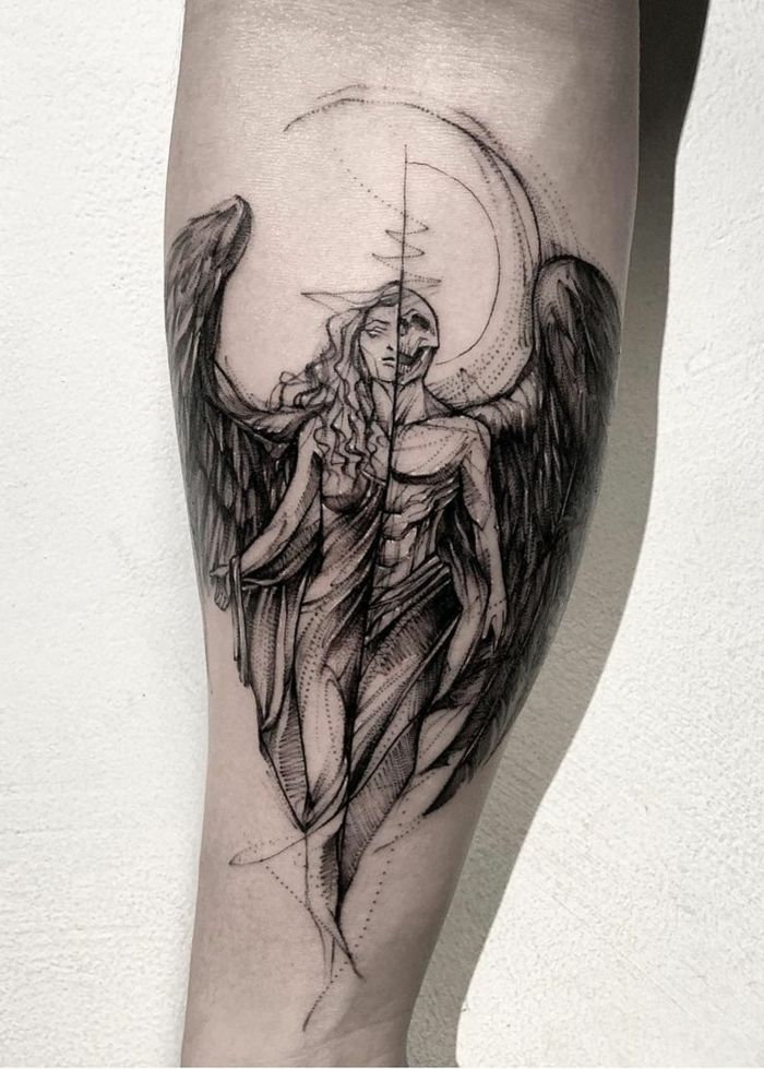 an angel with wings and a cross tattoo on the leg is shown in black and white