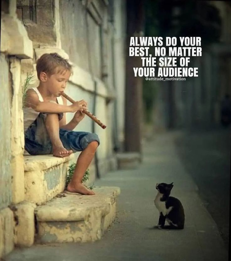 a little boy sitting next to a black and white cat with a baseball bat in his hand