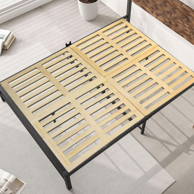 a bed frame with wooden slats on it