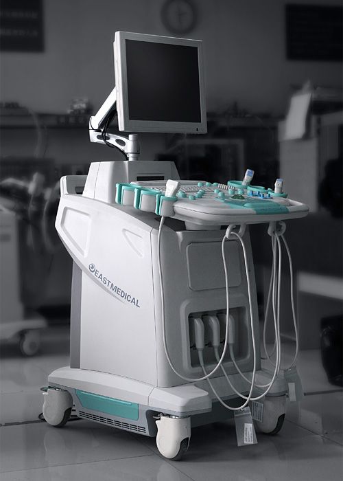 a hospital room with a monitor and medical equipment on it's stand, in black and white