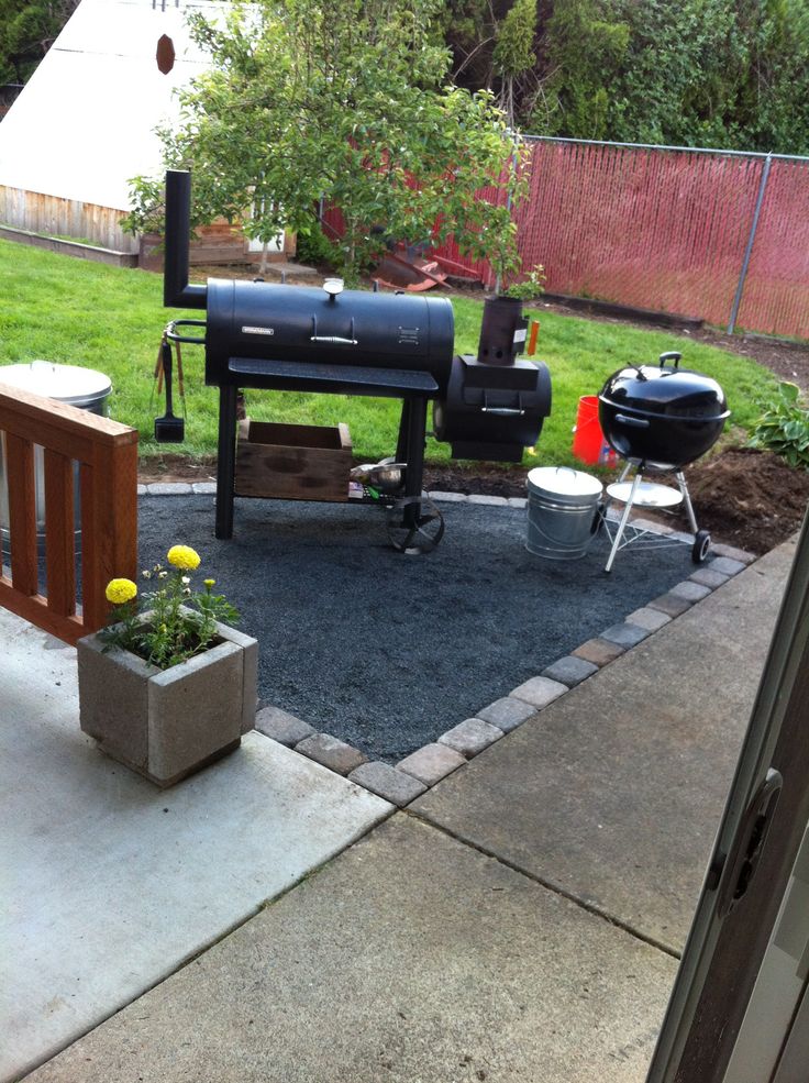 an outdoor bbq and grill in the back yard