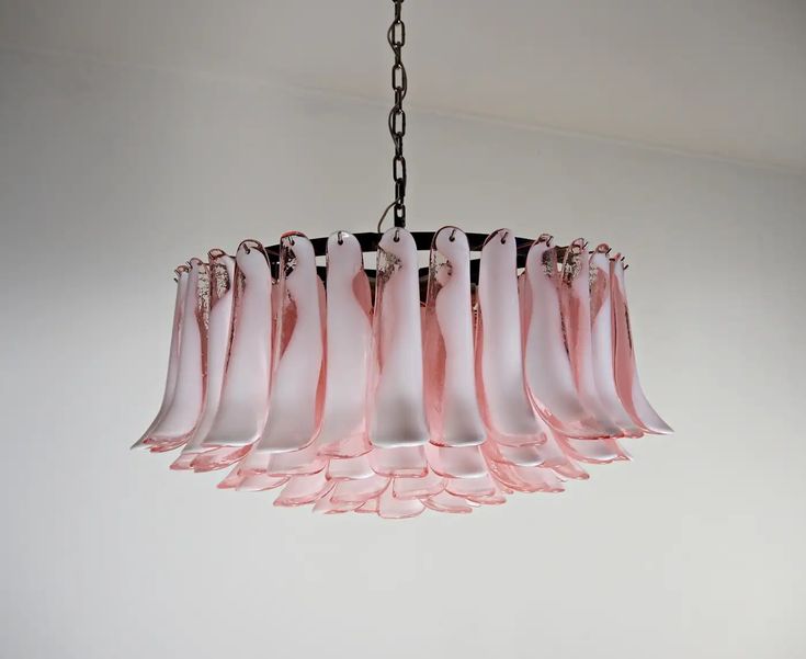 a pink chandelier hanging from a ceiling