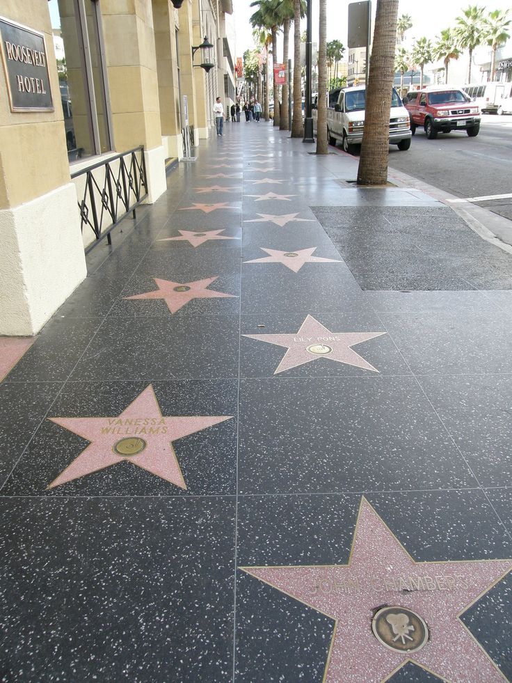 the hollywood walk of fame is lined with stars