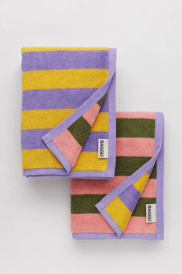 two purple and yellow striped towels on top of each other