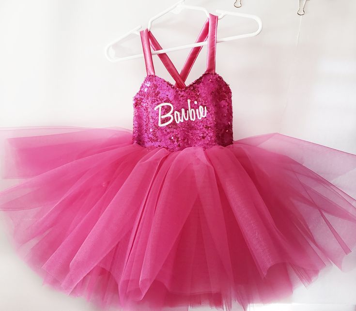 a pink tutule dress with the word buluov written in white on it