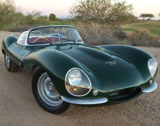 a green sports car parked in the dirt