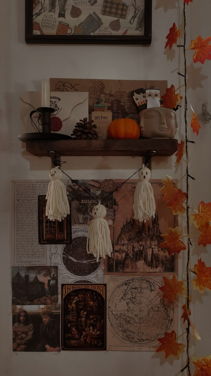 a shelf that has some pictures on it and pumpkins hanging from the wall next to it