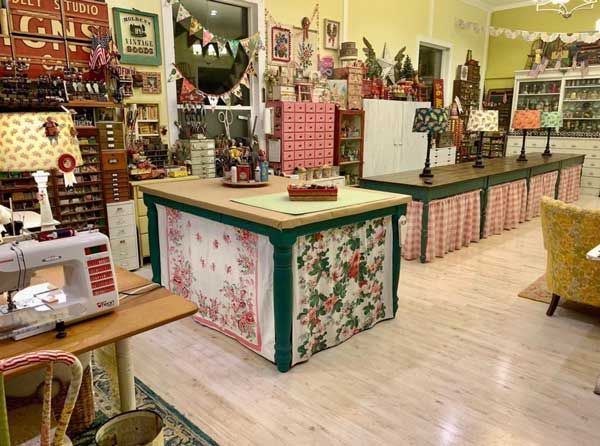 the inside of a sewing shop with many items on display