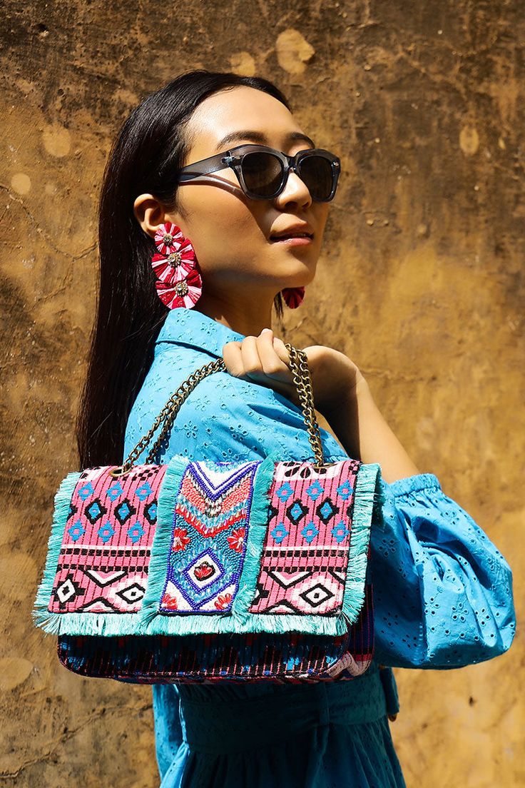 Multi Purpose Shoulder Bag, Intricate Hand Embellished Beadwork In Front Long Metallic Chain Strap Magnetic Button Closure Made In a Beautiful Patterned Hand-Woven Jacquard Fully Lined Interiors With Zip Pocket All Over Fringe Detail In Front Size : 10" X 6" X 3.5" Introducing our Southwest Floral Bloom Beaded Shoulder Bag the perfect accessory for adding a touch of cultural charm to your outfit. This multi-purpose shoulder bag is designed to be both stylish and practical, making it the ideal ch Bohemian Woven Party Bag, Bohemian Embellished Shoulder Bag, Multicolor Embroidered Shoulder Bag With Tassels, Chic Multicolor Embroidered Bag, Summer Bohemian Beaded Shoulder Bag, Bohemian Beaded Shoulder Bag For Summer, Embellished Multicolor Embroidery Bags, Bohemian Beaded Bags, Embellished Multicolor Summer Shoulder Bag