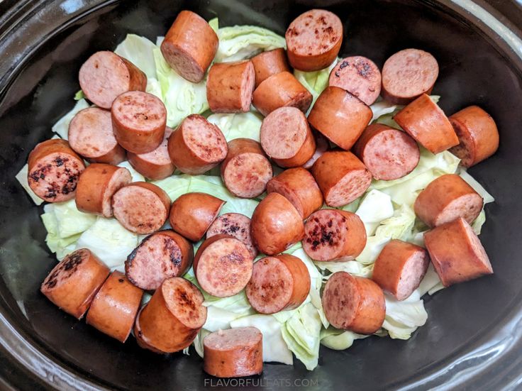 cooked sausages and cabbage in a slow cooker