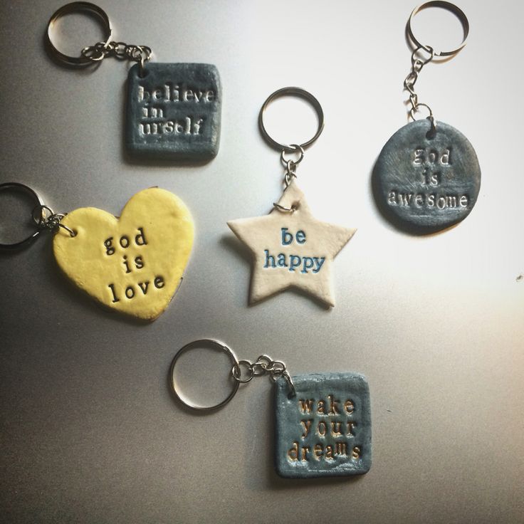 four different key chains with words on them