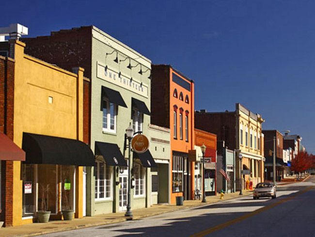 an empty street lined with buildings and shops