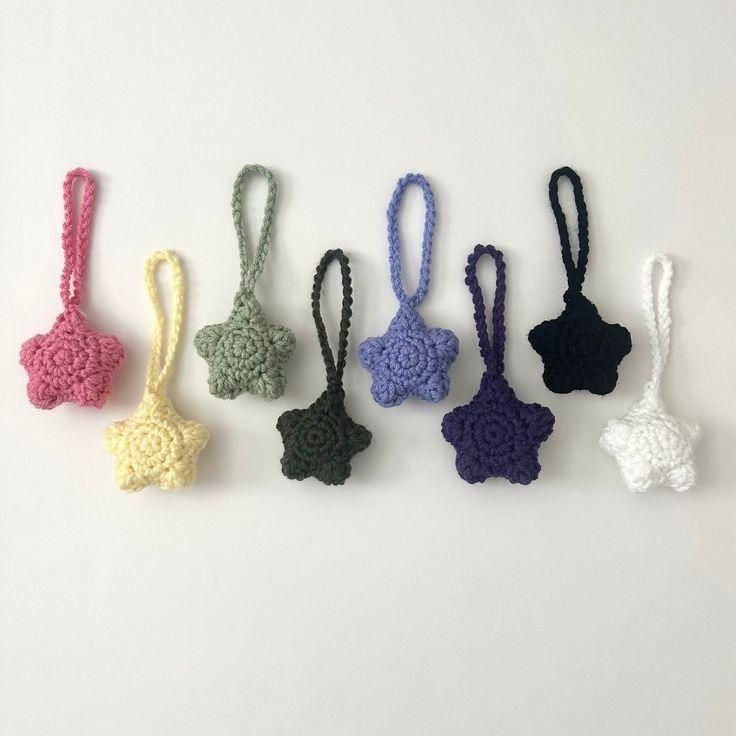 small crocheted items are lined up on a white surface