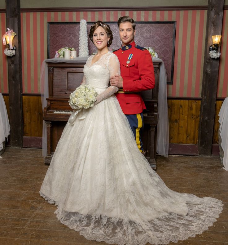 a bride and groom posing for a photo in front of a piano at their wedding