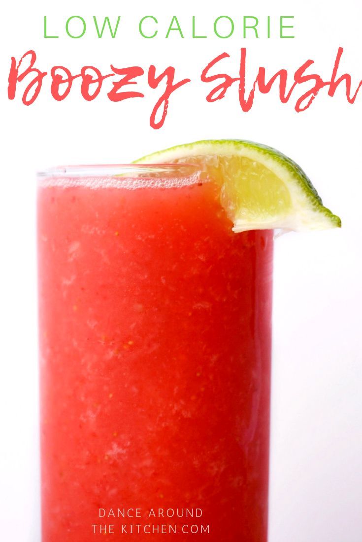 a red drink in a tall glass with a lime slice on top and the words low calorie boozy slush above it