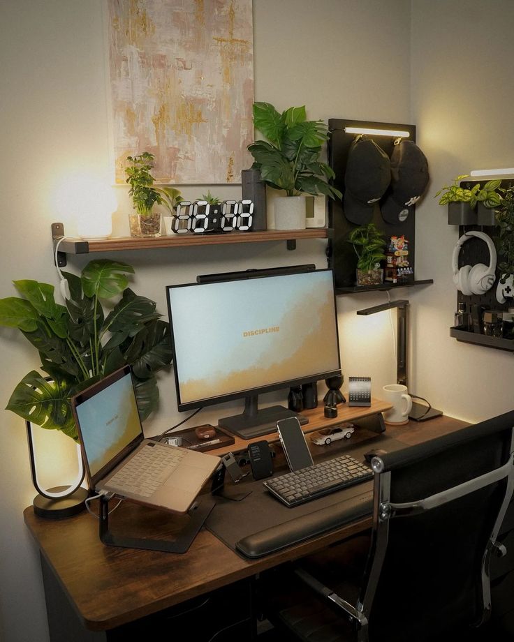 a desk with a computer, keyboard and mouse on it in front of some potted plants