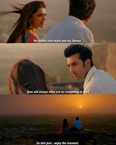 two people sitting next to each other on top of a hill with the sun setting behind them