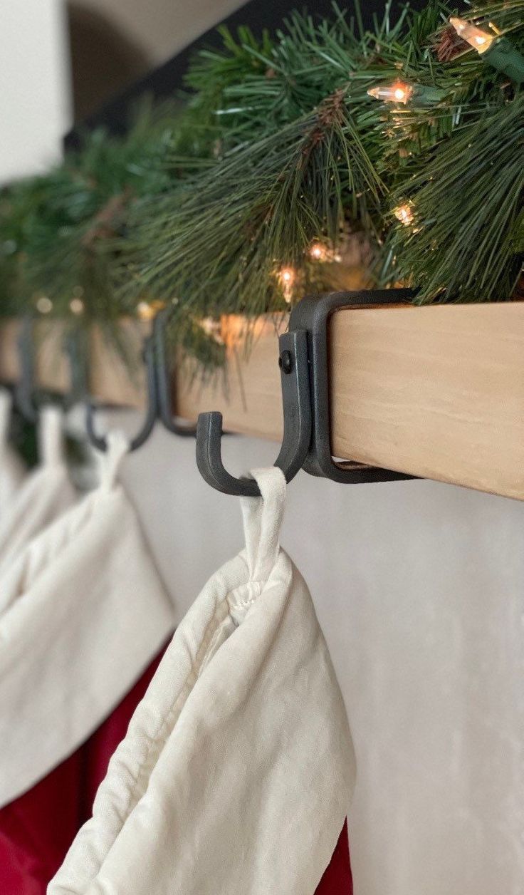 christmas stockings hanging from hooks on a wall