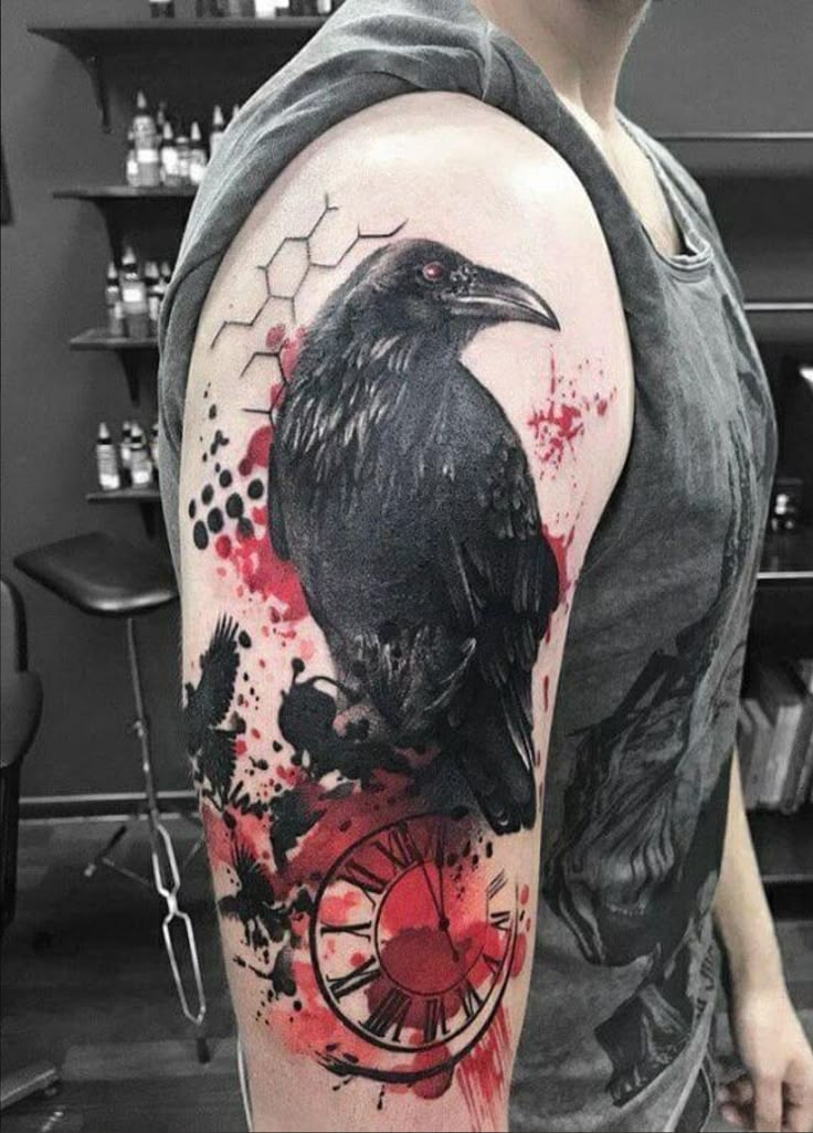 a man with a black crow on his arm and red paint splatters all over it