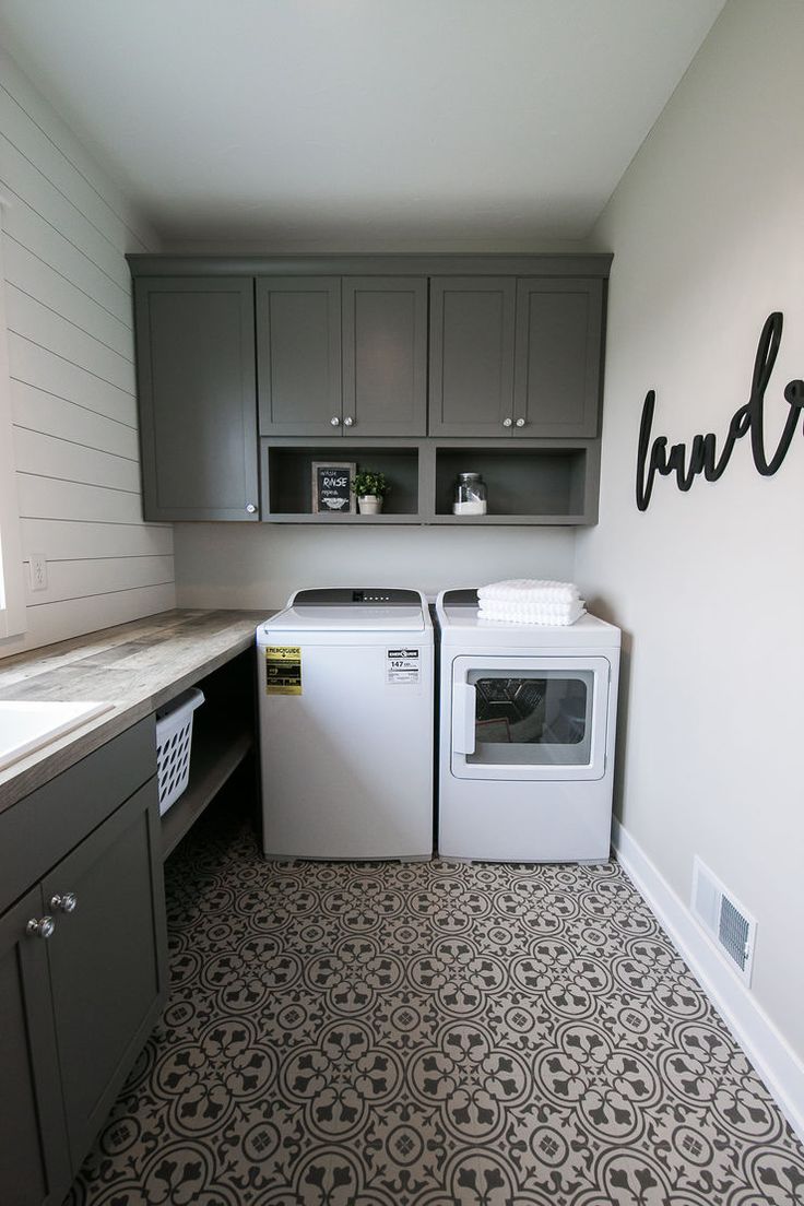 a washer and dryer sitting in a kitchen next to each other on the floor