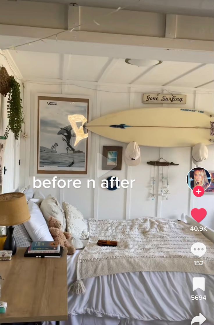 a bed room with a neatly made bed and a surfboard hanging from the ceiling