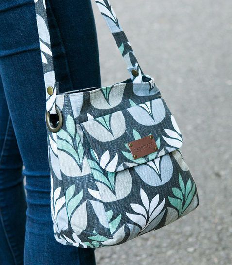 a woman carrying a purse on the street