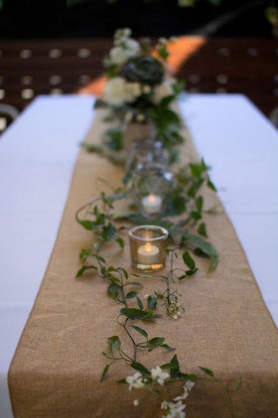 a long table with flowers and candles on it