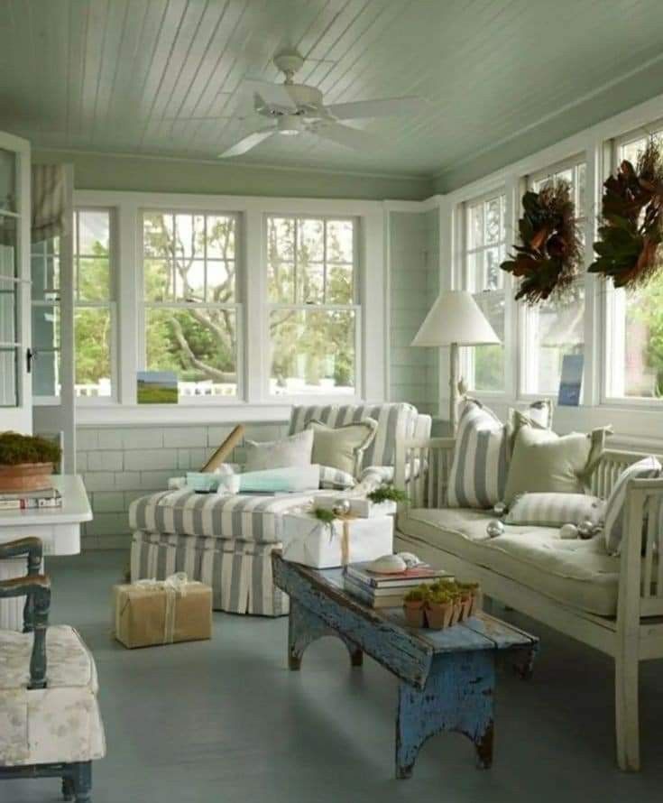 a living room filled with lots of furniture and decor on top of blue flooring