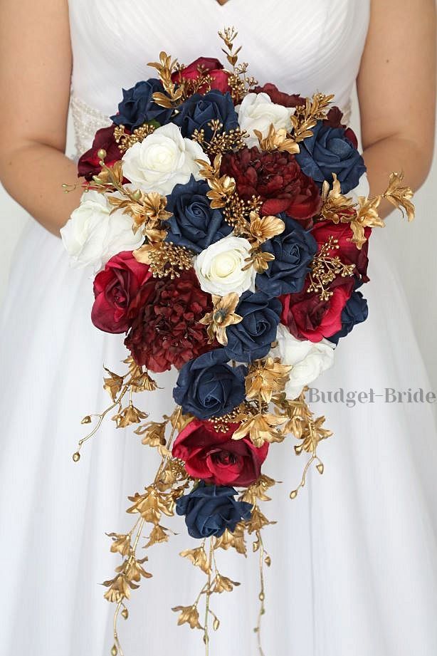 a bridal holding a bouquet of red, white and blue flowers