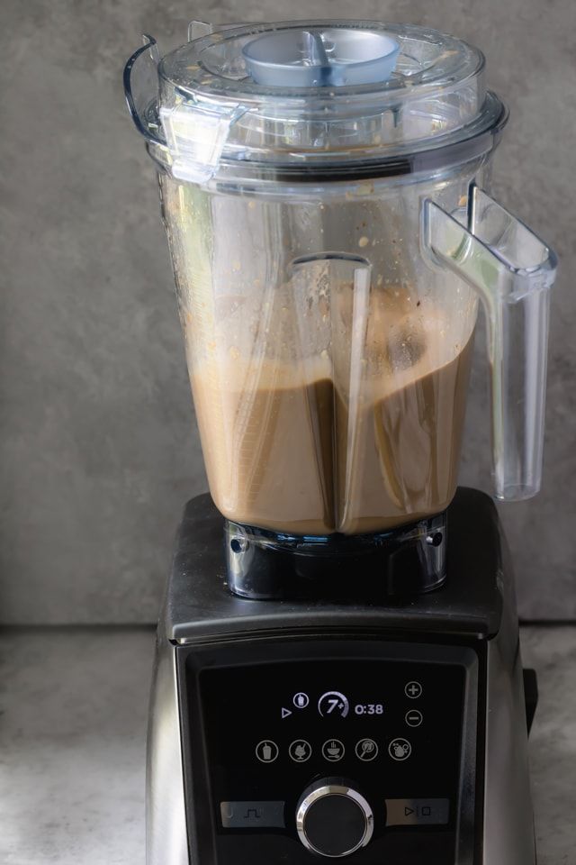 a blender filled with liquid sitting on top of a counter