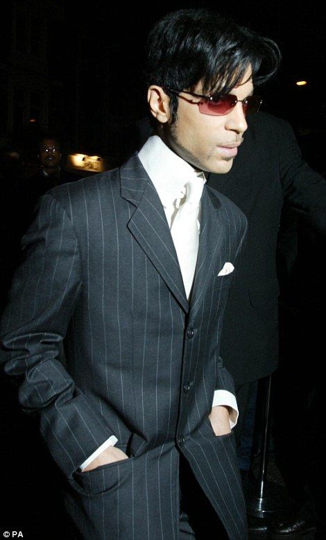 a man in a pinstripe suit and sunglasses