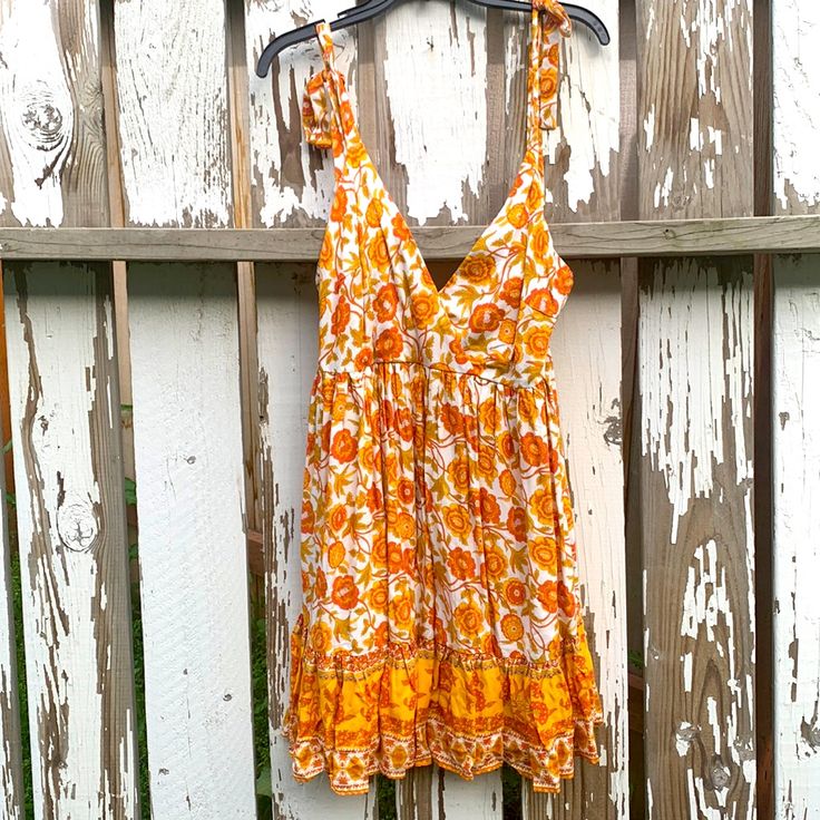 Orange Floral Dress New Without Tags. I Washed It And Bought For Self But It Did Not Fit. Floral Of Zinnias And Maybe Daffodil Like. Bohemian And Like An Indian Print Super Pretty Regular Price $69 Has A Slip With It Is 100% Rayon Wash And Cold Water And Do Not Tumble Dry Treat As A Delicate. The Floral Leaves Are Kind Of A Green Yellow I’m In Love With This Dress, It Has A Zipper In The Back. Flat Lay Pit To Pit Is Approximately 17 Inch. Waist Flat Lay Is 15 Inch. From Where The Strap Starts To Yellow Cotton Sundress For Vacation, Flowy Orange Boho Dress For Summer, Yellow Cotton Mini Dress For Vacation, Yellow Bohemian Sundress For Day Out, Yellow Floral Boho Dress For Summer, Yellow Bohemian Summer Dress, Yellow Bohemian Boho Dress For Vacation, Yellow Boho Dress For Vacation, Yellow Bohemian Dress For Vacation