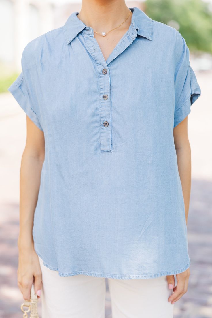 This chambray top is sure to make any outfit super cute! It's such a classic look. This chambray top is going to style easily with white shorts, jeans, or even printed midi skirts! Collared partial button down neckline Short sleeves No stretch Baileigh is wearing the small. Relaxed Fit Light Wash Denim Top For Day Out, Spring Light Wash Collared Denim Top, Short Sleeve Denim Top For Spring Day Out, Spring Short Sleeve Denim Top For Day Out, Casual Relaxed Fit Denim Top Made Of Tencel, Summer Chambray Collared Denim Top, Light Wash Chambray Denim Top For Day Out, Versatile Summer Blouse With Button Closure, Chic Light Wash Chambray Denim Top