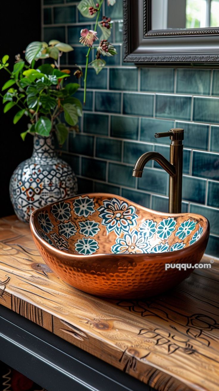 a bathroom sink sitting on top of a wooden counter next to a potted plant