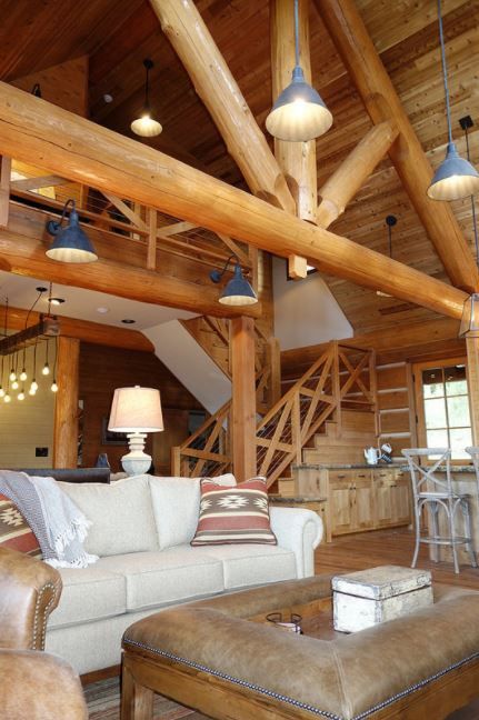 a living room filled with furniture and wooden beams