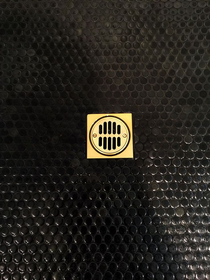 a close up of a black surface with a yellow sticker on the bottom that says,