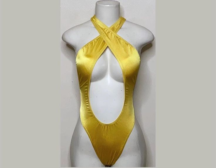 Welcome to my shop Let's Make Money Together 💕 DETAILS  * Handmade Item  * Materials: Nylon, Spandex * Crossover Bodysuit  * Never used  DESCRIPTION  * Thong Bodysuit  * Gold Shiny Spandex * 4 way stretch Fabric  * Mannequin is wearing XS/SMALL (may choose sizing at checkout)   SHIPPING  My current shipping turnaround is really quick 1 to 2 days  RETURNS & EXCHANGES  No refunds or exchanges if you have any issues with your purchase please feel free to reach me personally. I can accommodate on y Fabric Mannequin, Club Attire, 4 Way Stretch Fabric, Rave Outfits, Womens Bodysuit, Catsuit, Dance Wear, Crossover, Make Money