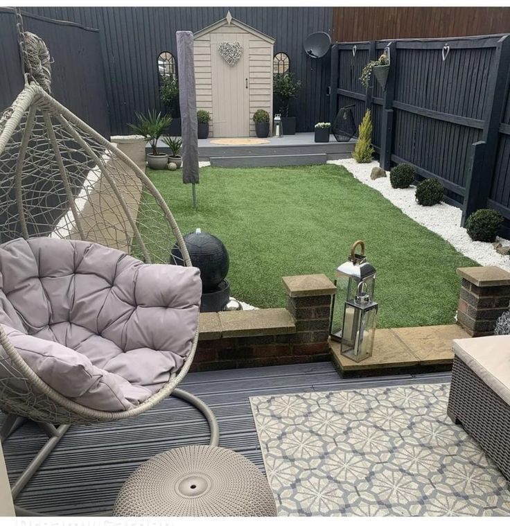 a backyard with grass and furniture in it