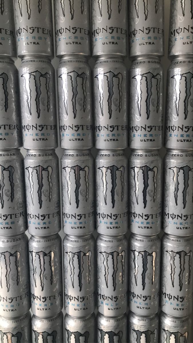 several cans of monster energy drink stacked on top of each other